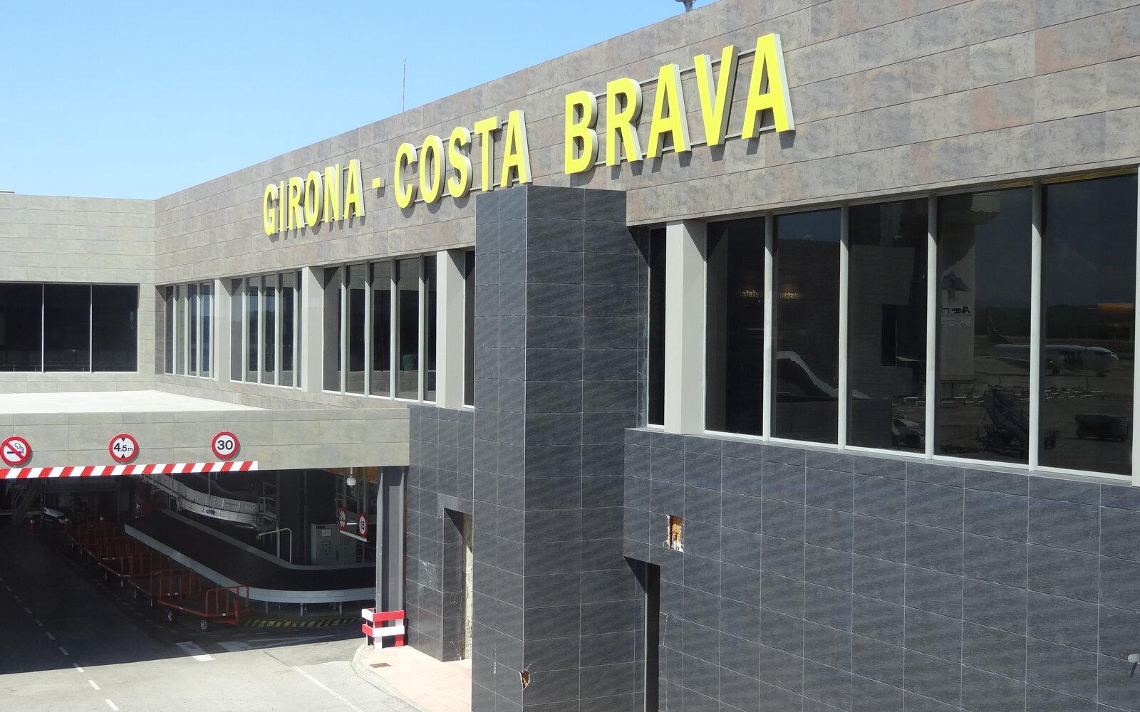 Girona-Costa Brava Airport terminal façade with its yellow terminal sign