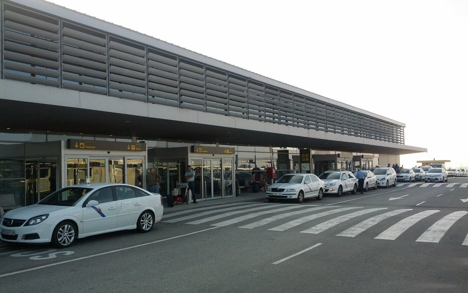 Reus Airport terminal exterior with taxis waiting at the entrance
