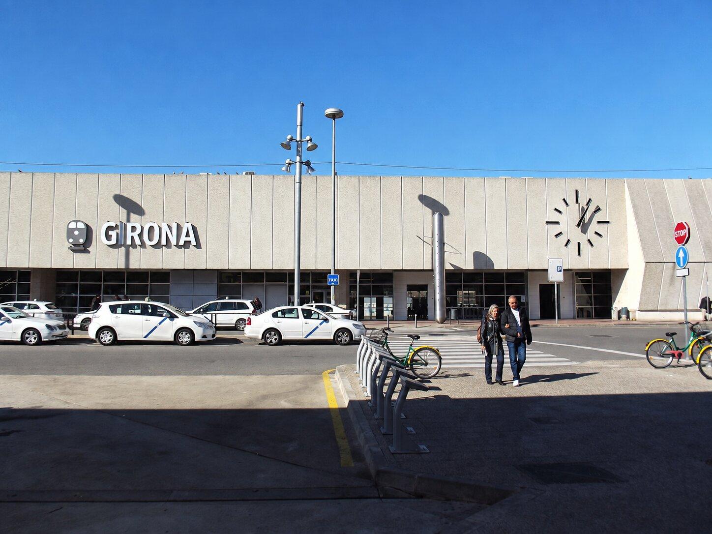 Taxis and bicycles outside the entrance to Girona railway station
